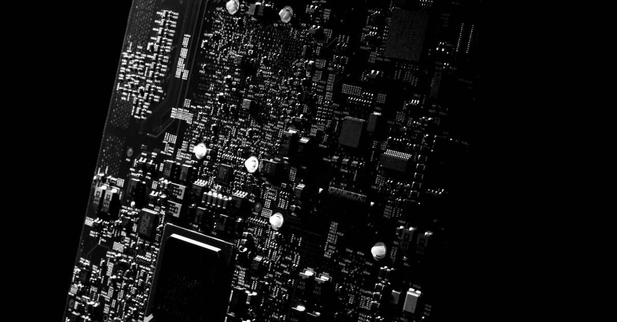 Detailed black and white close-up of a circuit board showcasing modern technology.
